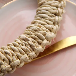 Close-up of natural woven fiber napkin ring with detailed spiral braided texture