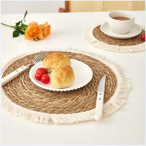 Close-up of a woven grass heat-insulated placemat with elegant white fringe details