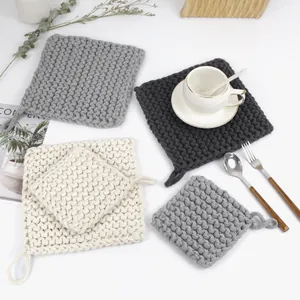 Detail of square woven cotton placemats with convenient hanging loops in neutral colors