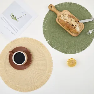Minimalist round woven placemats with fringe edge in olive green and beige colors
