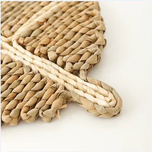 Close-up of woven leaf-shaped placemat showing natural fibers and thick textures