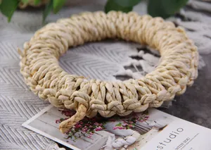 Close-up of handmade round straw placemat showing rustic texture and thick weave detail