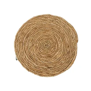 Handwoven round natural fiber placemat with reinforced spiral weave for heat insulation
