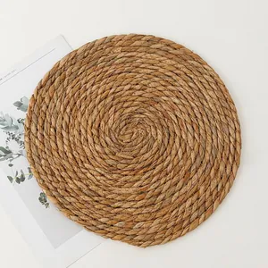 Top-down view of round cattail woven placemat showing natural fibers and spiral texture