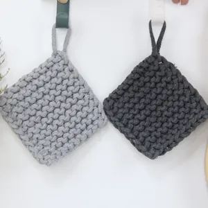 Close-up of thick cotton woven placemats in grey with hanging loops for kitchen storage