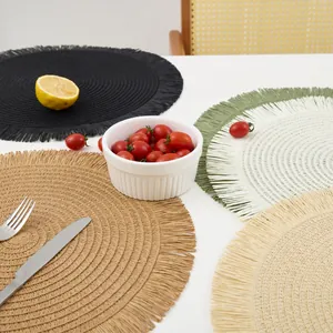 Detail of hand-woven round placemat with fringe edges and spiral texture pattern