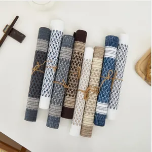 Set of eight woven heat-resistant placemats with geometric patterns and rope binding