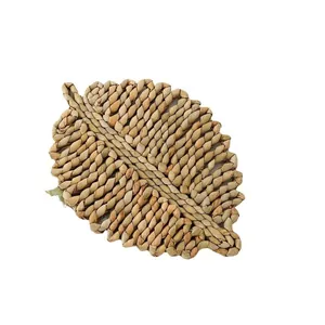 Leaf-shaped woven placemat handcrafted with natural fibers for home table decoration