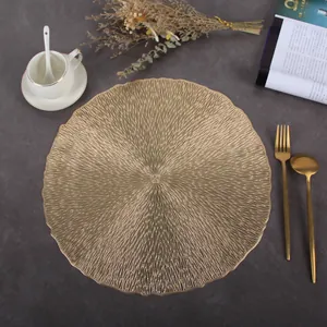 Macro shot of gold circular PVC placemat with radial texture and scalloped edges