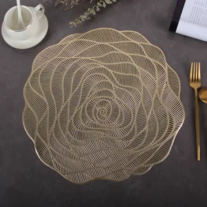 Macro detail of golden circular hollow placemat with elegant spiral floral pattern