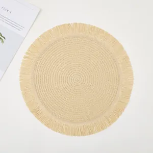 Detail of round woven placemat with elegant fringe edges for bohemian table decor