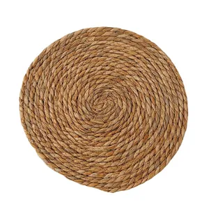 Handcrafted circular woven grass placemat made of natural fiber for heat insulation