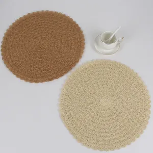 Detail of round woven placemats in caramel and cream showing intricate lace patterns