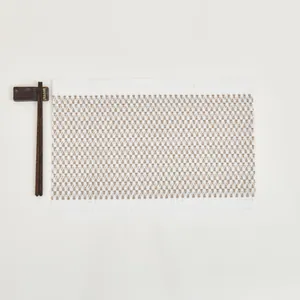 Close-up of beige woven rectangle placemat featuring heat-resistant geometric texture