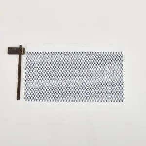 Detail of woven table mat with blue and white geometric triangle patterns