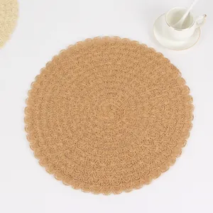 Macro detail of round scalloped woven placemat with natural brown textured ripples