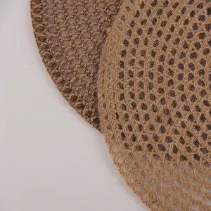 Detail of round woven jute placemat showing intricate natural fiber texture and pattern