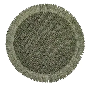 Macro detail of round woven placemat with fringed edges in natural grey-green fiber