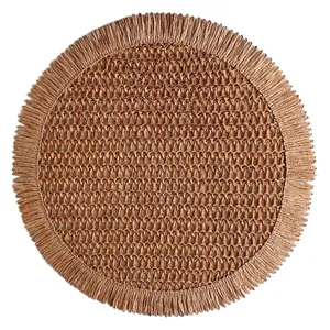 Close-up of circular woven placemat with natural fiber texture and fringe edges
