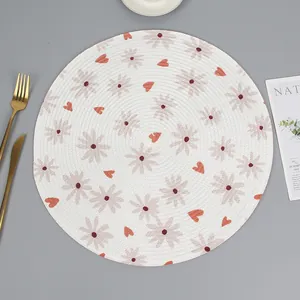 Detail of round woven placemat with floral daisy print and heat-resistant spiral texture
