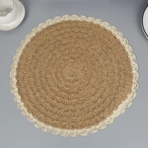 Round woven placemat with natural fiber texture and decorative wave-shaped hollow lace edges