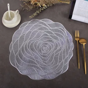 Detail of silver hollow PVC placemat with elegant floral pattern on stone background