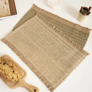 Detail of woven table mat with fringe edge in cream and olive green colors