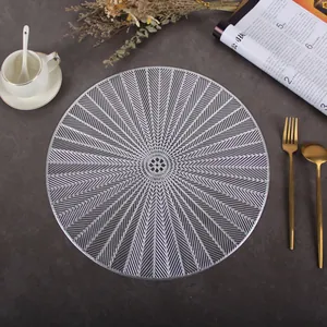 Detailed view of round silver hollow PVC placemat with elegant vein texture on a table