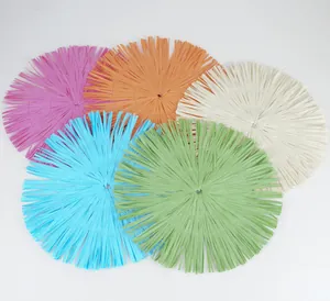 Macro shot of circular placemats with fringe edge made of woven paper fiber in five colors