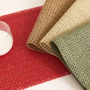 Detail of woven table mats in red, beige and green with heat-resistant mesh texture