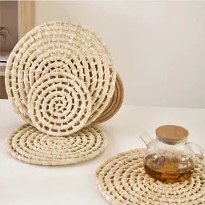 Detailed view of hand-woven natural corn husk coasters showing spiral braided texture