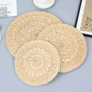 Handcrafted round straw placemats in natural wood tones for stylish table protection
