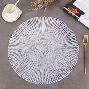 Close-up of silver hollowed round PVC place mat with elegant concentric patterns