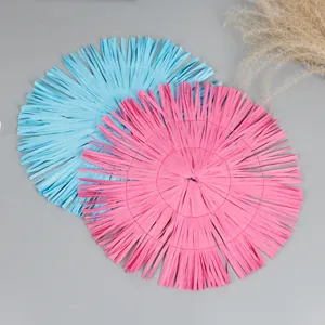Set of two round paper woven placemats with fringe in light blue and pink colors