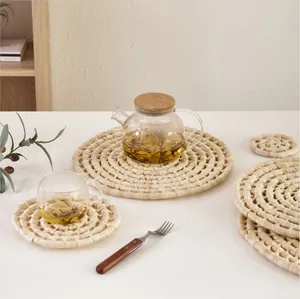 Close-up of hand-woven natural corn husk placemats with a spiral rustic texture