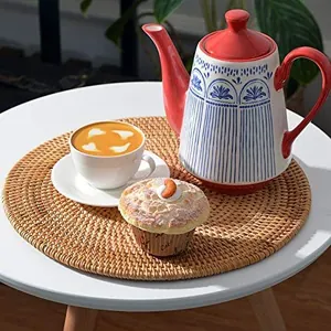 Handwoven round rattan placemat used as a heat-resistant coaster for coffee and tea