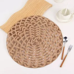 Detailed top view of a handmade round ramie placemat with spiral weave and floral center