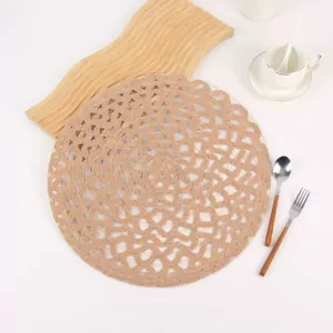 Handwoven round ramie placemat with hollow geometric pattern in natural brown color