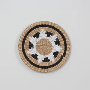 Macro shot of hand-woven round wall decor featuring geometric wave patterns in natural fibers