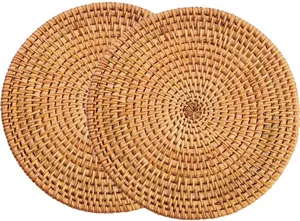 Close-up of two natural rattan round placemats with dense spiral woven texture