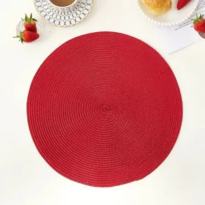 Detailed macro view of a round red woven placemat with intricate spiral heat-resistant textures