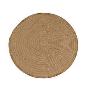 Handwoven round straw placemat with decorative fringe edges for dining table decor