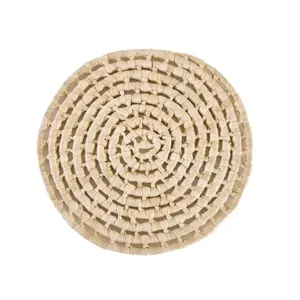 Handcrafted circular maize husk placemat with natural fiber weave for table decor