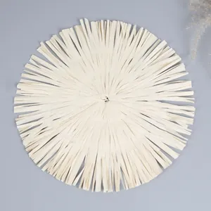 Detail of round woven paper placemat with fringe edges for bohemian home decor
