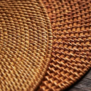 Close-up of natural rattan placemat showing tight spiral handwoven texture and detail