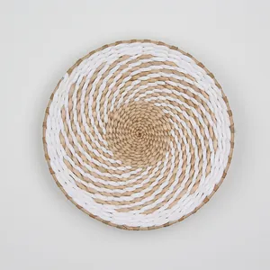 Detail of hand-woven natural straw and white fiber wall decor with spiral texture