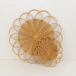 Two-piece heat resistant round woven placemats in a natural bohemian floral sun design