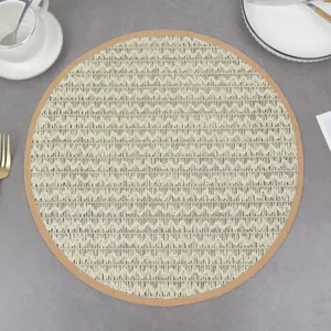 Close-up of a woven cream placemat with cork edge on a grey stone dining table