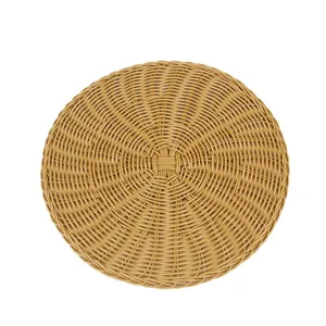 Round faux rattan woven heat-resistant placemat with spiral pattern in brown