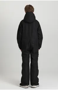 Detail view of children's waterproof black ski jumpsuit with adjustable waist and cuffs